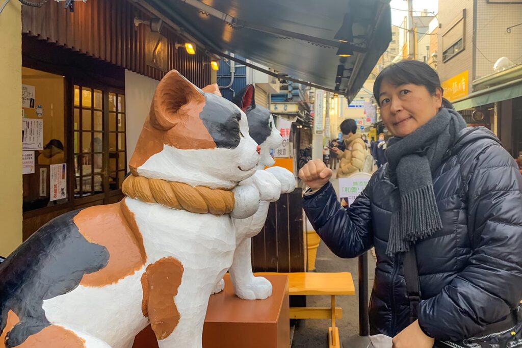 Tourist with Cat Statue