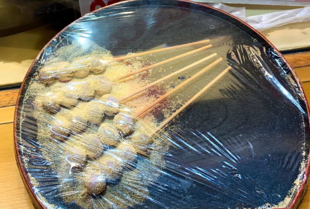 Dango, sweet grilled rice dumplings coated in soy-based sauce, a traditional snack from Asakusa.